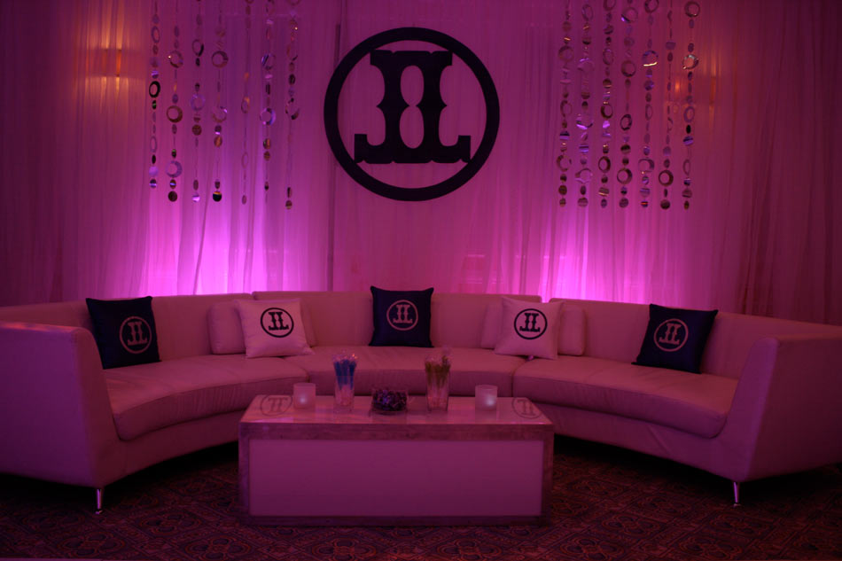 Curved-couch-personalized-pillows-logo-cut-out-drapes-with-lighting-and-foil-dot-curtains